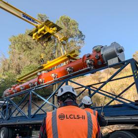 LCLS-II crew members work to carefully unload a cryomodule delivery from Jefferson Lab.